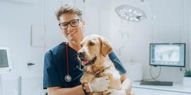 Vet smiling with dog