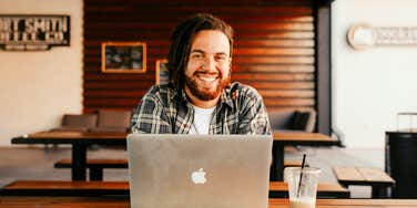 Young wealthy man sitting at his computer.