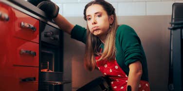 Woman cooking as a guest in someone's home