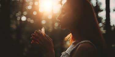 Woman using a crystal to attract money and success