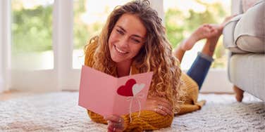 Woman reading Valentine's Day card from her dad