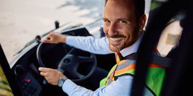 school bus driver smiling at camera