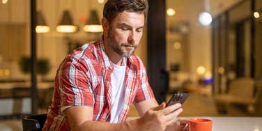 Man changing his phone settings to protect his sensitive information