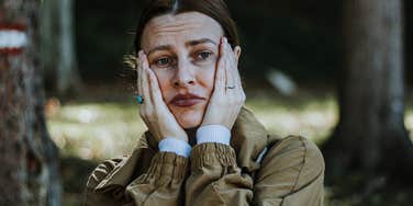 upset woman holding her face in her hands