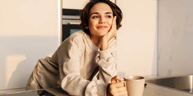 Woman having a peaceful coffee in the morning, becoming wiser. 