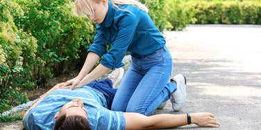 Woman giving a man CPR