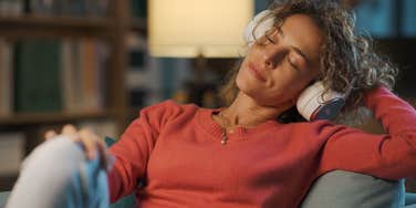 peaceful woman listening to music at night