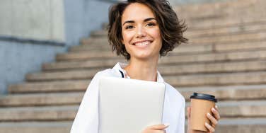 Young woman with laptop practicing hot girl habits for a better life