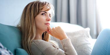 Woman thinking about why she feels so emotionally exhausted after spending time with family