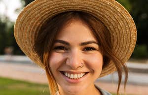 smiling happy woman wearing a hat