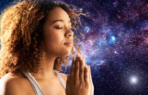 woman meditating manifesting with galaxy background