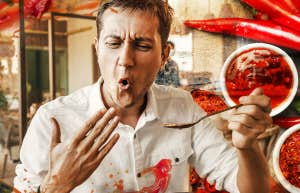 Man trying to cool off mouth after eating spicy food