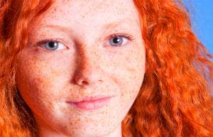 girl with bright red hair smiling