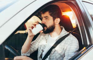 man in car drinking coffee without a care 