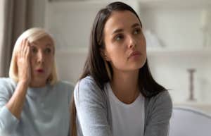 sad adult woman with older woman behind her