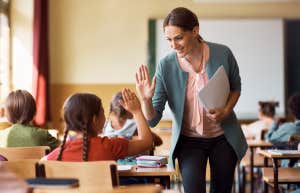 happy teacher in classroom