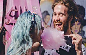 man feeding woman cotton candy