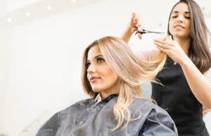 Woman getting her hair cut by a hair stylist. 