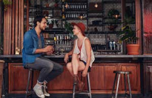 man and woman sitting at cafe counter