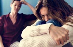 woman and teenager sitting together angry