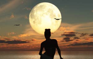 woman sitting by moon